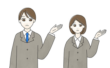 笑顔で案内するスーツ姿の男性と女性