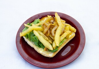 French fries on toast with fresh lettuce isolated on a clear background with copy space