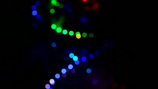 Christmas abstract blurred background. Multi-colored lights. Unfocused image with colorful lights on black. Soft focus