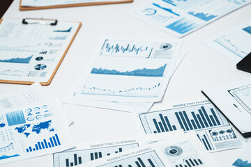 Piles of business intelligence paper or BI financial report and financial data visualization on...