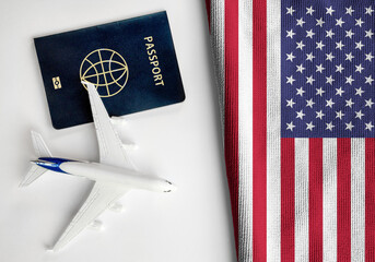 Flag of United States with passport and toy airplane. Flight travel concept