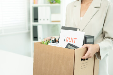 resignation, leave, quit, Stressful businesswomen will resign from the company. Female staff is lifting a brown paper box that holds personal items. , job placement and vacancies, resignation letter - obrazy, fototapety, plakaty
