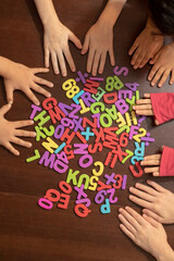 Kids hands holding Educational colorful numeral figures. Show numbers concept