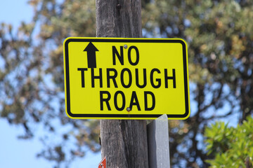 Bright yellow "No Through Road" sign