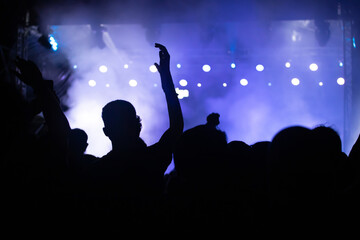 Fototapeta premium Abstract photo of crowd at concert and blurred stage lights.