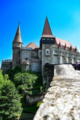Fototapeta na wymiar The famous Hunedoara Castle, Castelul Corvinilor or Corvin Castle with the Podul de Lemn castle bridge in summer with a blue sky, Hunedoara, Transylvania, Romania