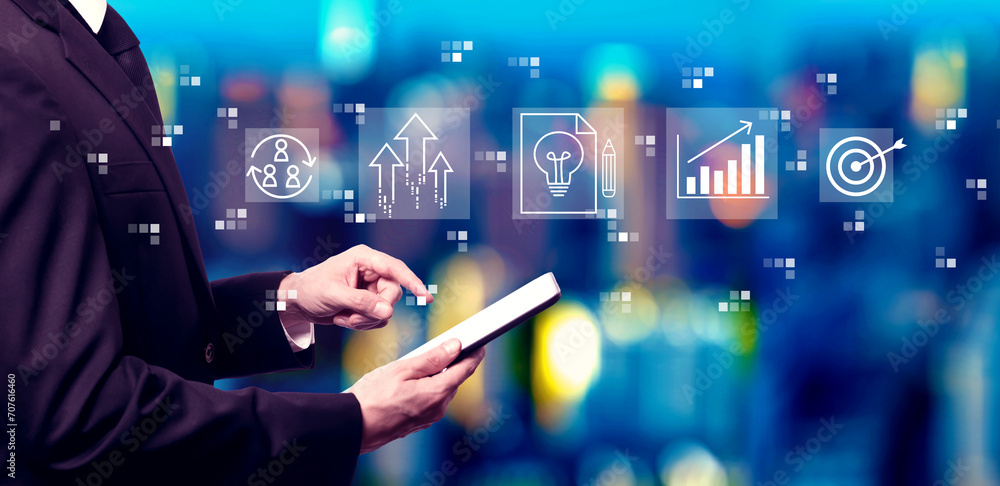 Poster idea of success theme with businessman using a tablet computer at night
