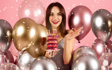 A woman with a bright smile and red lipstick, wearing a sparkling dress