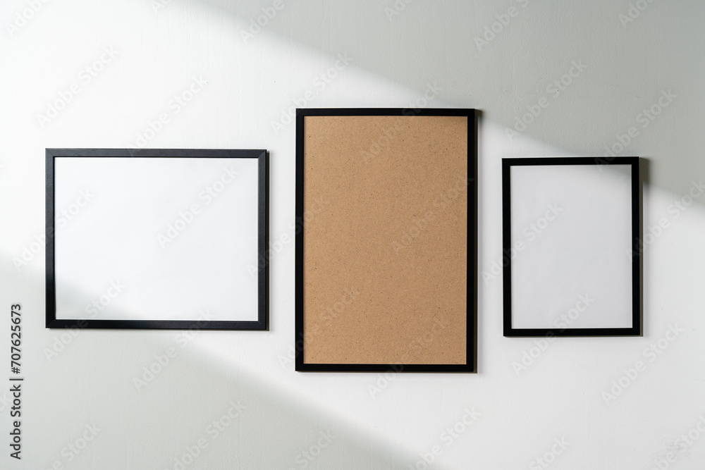 Poster Blank picture frames on the white wall copy space