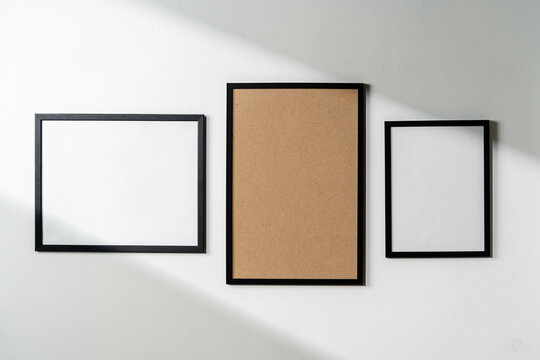 Blank picture frames on the white wall copy space