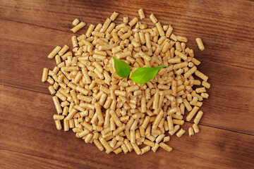 Heap of wooden pellets biofuel on wooden table