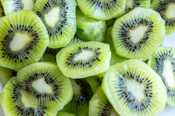 background of freshly cut organic kiwifruit slices, health food concept