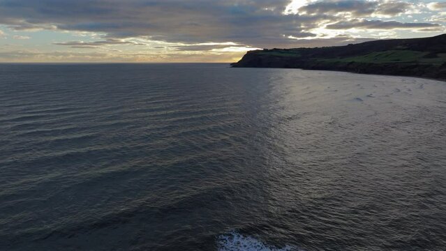 Establishing Drone Shot over Sea of North Yorkshire Cliffs Coastline