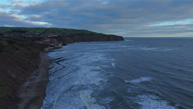 Establishing Drone Shot of Robin Hoods Bay and Sedimentary Cliffs UK
