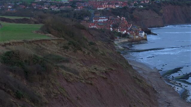 Establishing Aerial Shot of Sedimentary Cliffs and Robin Hood's Bay UK