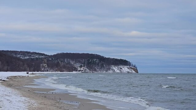 Cliffs in Gdynia Orlowo during cold winter morning. Beach covered with snow.