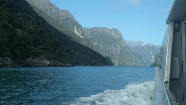 Maritime marvel: Boat gracefully enters Milford Sound in captivating stock footage. Nature's fjord beauty unfolds in cinematic allure