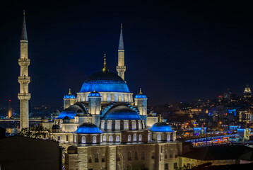 Fototapeta na wymiar Evening cityscape of the Historic Peninsula with Yeni Cami or New Mosque at night after sunset in Istanbul, Turkey