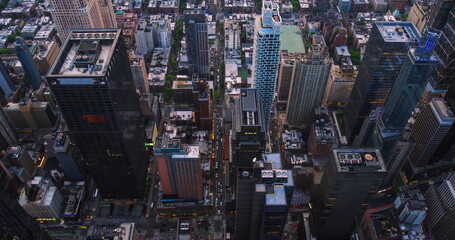 Top Down Aerial View of New York City Streets with Old Residential Buildings Contrasting with Modern Skyscrapers and Construction Sites. Busy Urban Center Cars, Yellow Taxis and Commercial Vehicles
