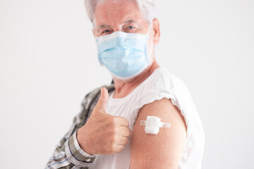 Old caucasian senior man wearing mask prevents covid coronavirus infection by vaccination.