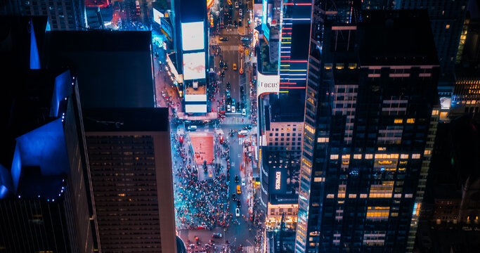 Helicopter Night Tour of New York City. Lit Times Square with Colorful Mock Up Advertising Billboards and Groups of Tourists Enjoying Manhattan Nightlife and Admiring the Landmark