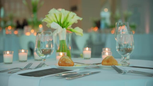 Luxury Restaurant banquet table set up served dinner tableware and silverware on wedding event. Move camera footage. Close up