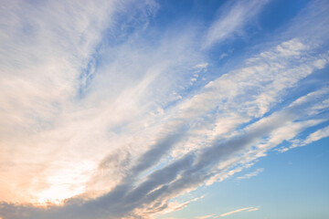 A beautiful sky tinted by the sun leaving vibrant shades of gold, pink, blue and multicolored. Clouds in the twilight evening and morning sky. Cloudy sky background in the evening and during the day.
