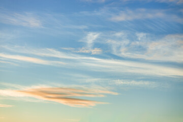 A beautiful sky tinted by the sun leaving vibrant shades of gold, pink, blue and multicolored. Clouds in the twilight evening and morning sky. Cloudy sky background in the evening and during the day.