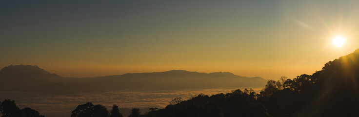 travel and people activity concept with twilight sky before sunrise with mountain and fog on foreground