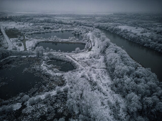 Winter Wonderland from Above: Frozen Lakes and Icy Treetops Captured by Drone