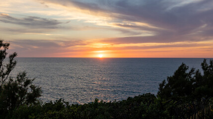 Fototapeta na wymiar sunset yellow and red sunshine over the sea coast water