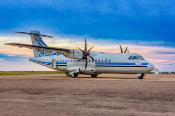 propeller plane passenger transport parked in the runway for refueling