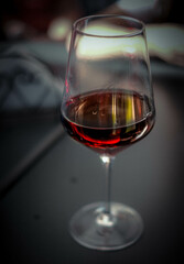 glass of wine at the table of a bar for an aperitif in the Piedmontese Langhe during the grape...
