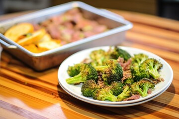 beef and broccoli with a side of garlic bread on a tray