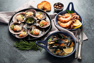 Fried scallops with butter and green sauce served in seashells.