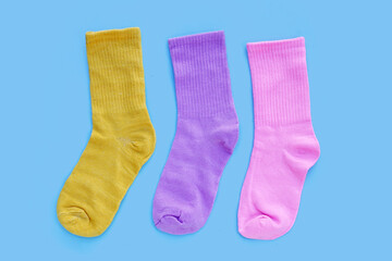 Colorful socks on blue background.