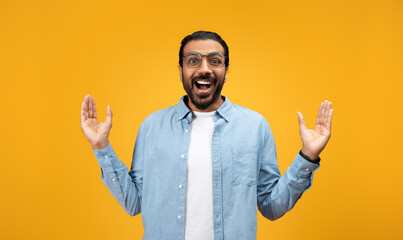 Exuberant man with a beard and glasses, arms raised in a welcoming gesture