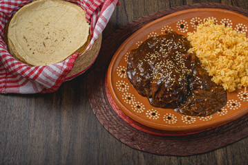 Mole, typical Mexican food. Traditional Mexican dish served in a clay dish.
