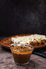 Homemade spicy red sauce for tacos. Traditional Mexican sauce in a glass bowl.