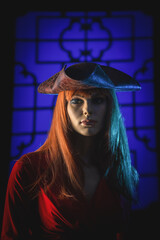 Beautiful female dummy in the pirate hat on a window lights background concept.