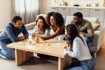 International students group bonding over a board game in kitchen