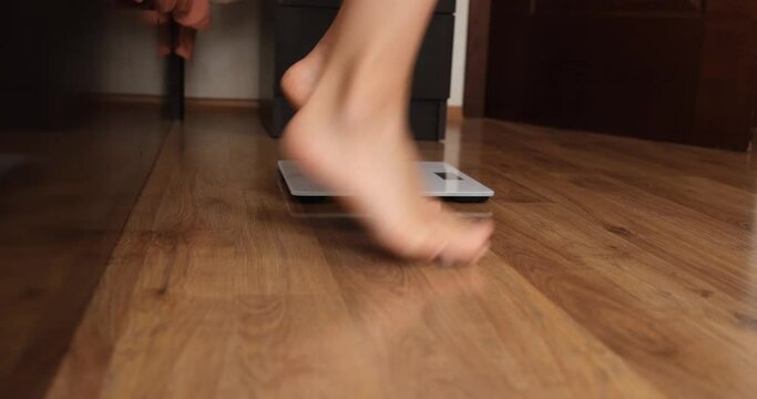 Women legs and weight measurement and joyful jumping. Weight loss concept