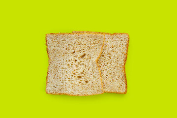 Whole wheat bread  isolated on green background.