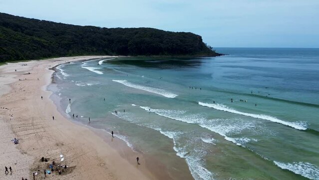 Drone aerial beach people at beach headland bushland coastline waves rural town holiday Durras North Batemans Bay travel tourism South Coast Australia