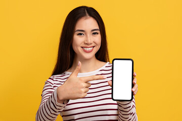 Pretty young asian woman showing phone with white screen