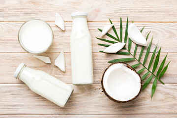 Obraz na płótnie Canvas coconut products on white wooden table background. Dairy free milk substitute drink, Flat lay healthy eating