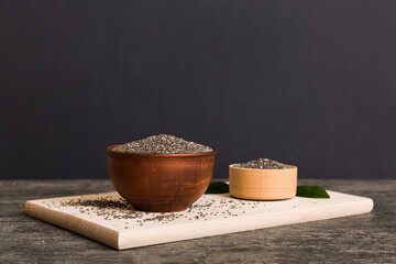 Chia seeds in bowl on colored background. Healthy Salvia hispanica in small bowl. Healthy superfood