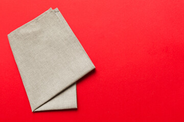 top view with gray kitchen napkin isolated on table background. Folded cloth for mockup with copy...