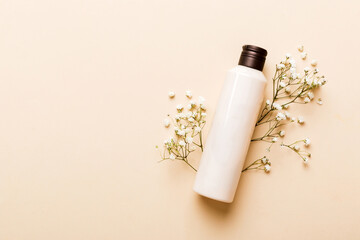 Fancy healthcare bottles for cream with gypsophila branch. Natural oranic spa cosmetics concept....