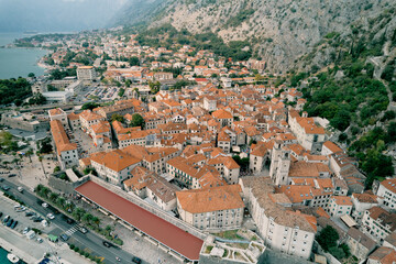 Fototapeta na wymiar Embankment of the ancient town of Kotor at the foot of the mountains. Montenegro. Aerial view